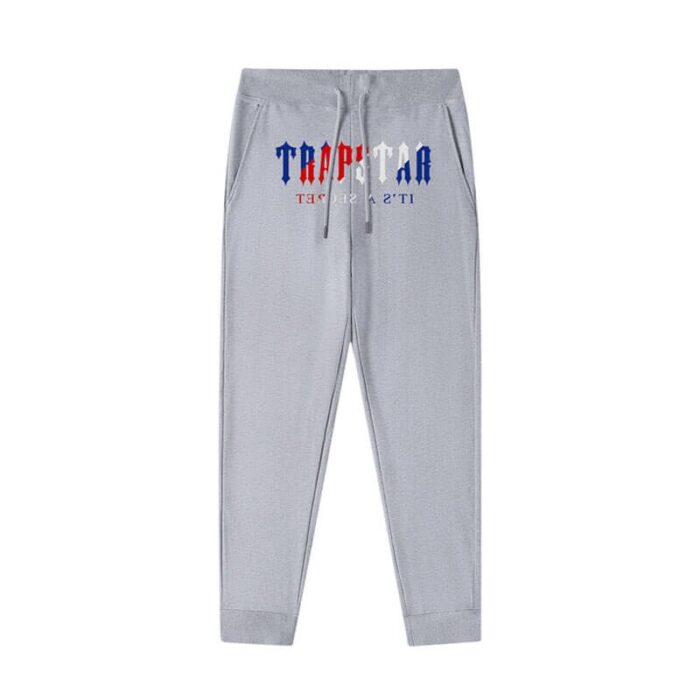 "Autumn Trapstar It's a Secret Logo Grey Joggers - Embrace the cozy vibes of fall in these stylish grey joggers featuring the iconic Trapstar logo, a perfect blend of comfort and streetwear flair for the autumn season."